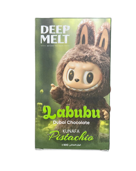 Chocolate bar packaging with a bear design held by a hand on a tiled floor.