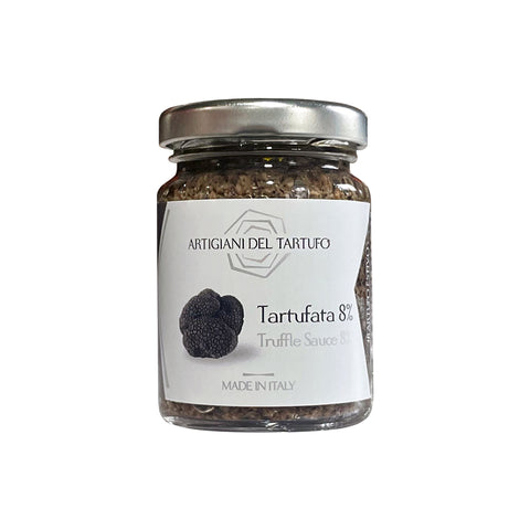 A glass jar of Artigiani Del Tartufo truffle paste with a label showing the product name and 'Made in Italy' indication.